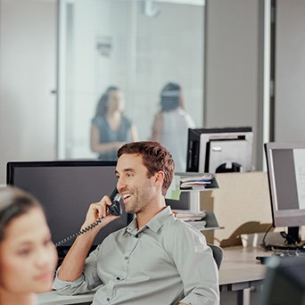 A Man Gray Shirt Talking On A Telephone - Cloud Analytics Platform - Infront